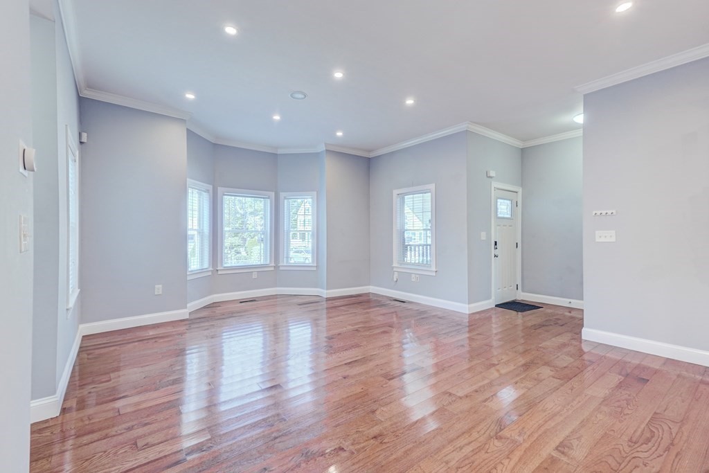 1008-1010 River Street, Unit 1 Boston, MA 02136 - Photo 16 of 29 a view of an empty room with wooden floor and window