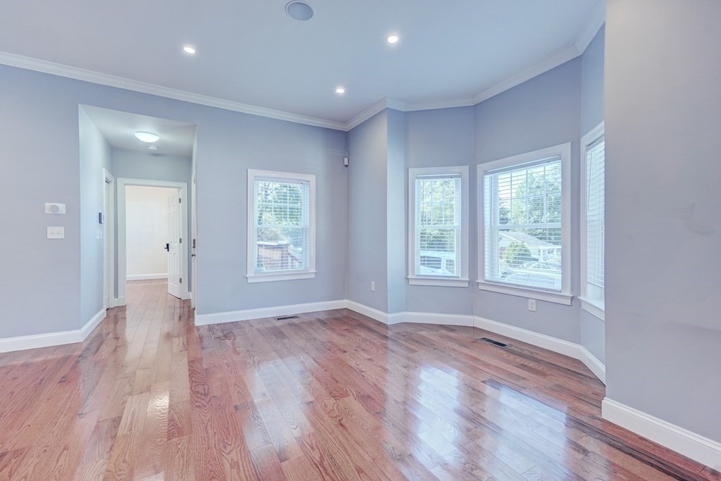 1008-1010 River Street, Unit 1 Boston, MA 02136 - Photo 17 of 29 a view of empty room with wooden floor and fan