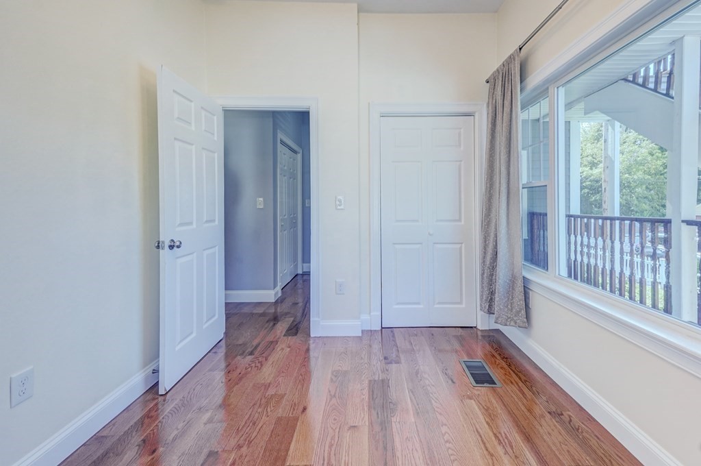 1008-1010 River Street, Unit 1 Boston, MA 02136 - Photo 20 of 29 a view of hallway with a large window and wooden floor