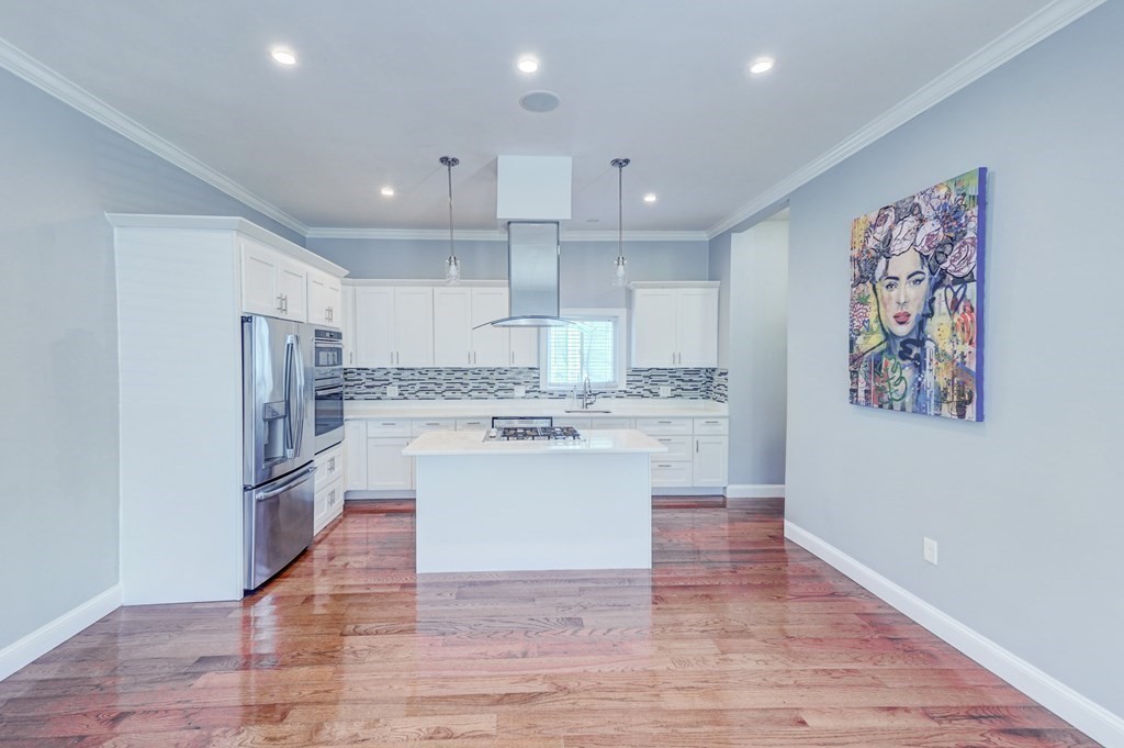 1008-1010 River Street, Unit 1 Boston, MA 02136 - Photo 3 of 29 a kitchen with stainless steel appliances granite countertop a refrigerator and a stove top oven
