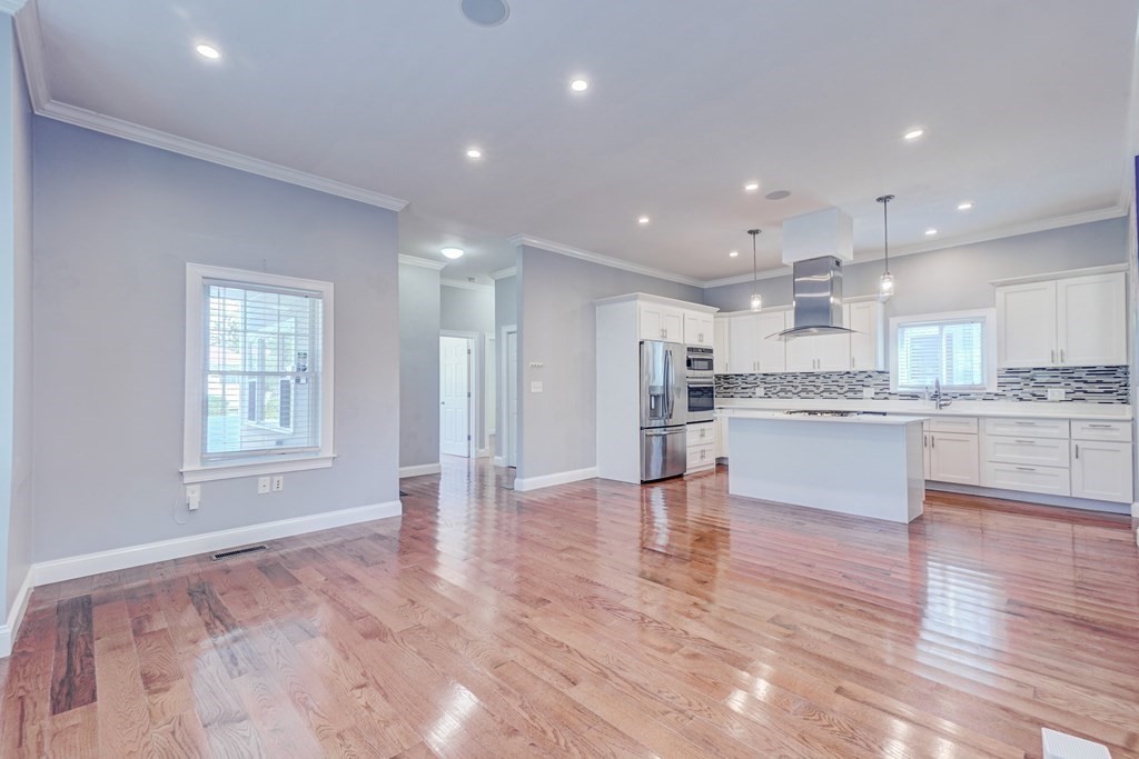1008-1010 River Street, Unit 1 Boston, MA 02136 - Photo 4 of 29 a view of kitchen with kitchen island and stainless steel appliances