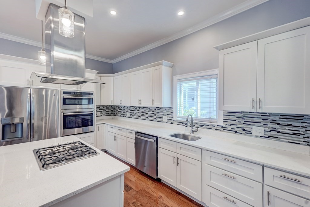 1008-1010 River Street, Unit 1 Boston, MA 02136 - Photo 6 of 29 a kitchen with stainless steel appliances a sink stove and cabinets