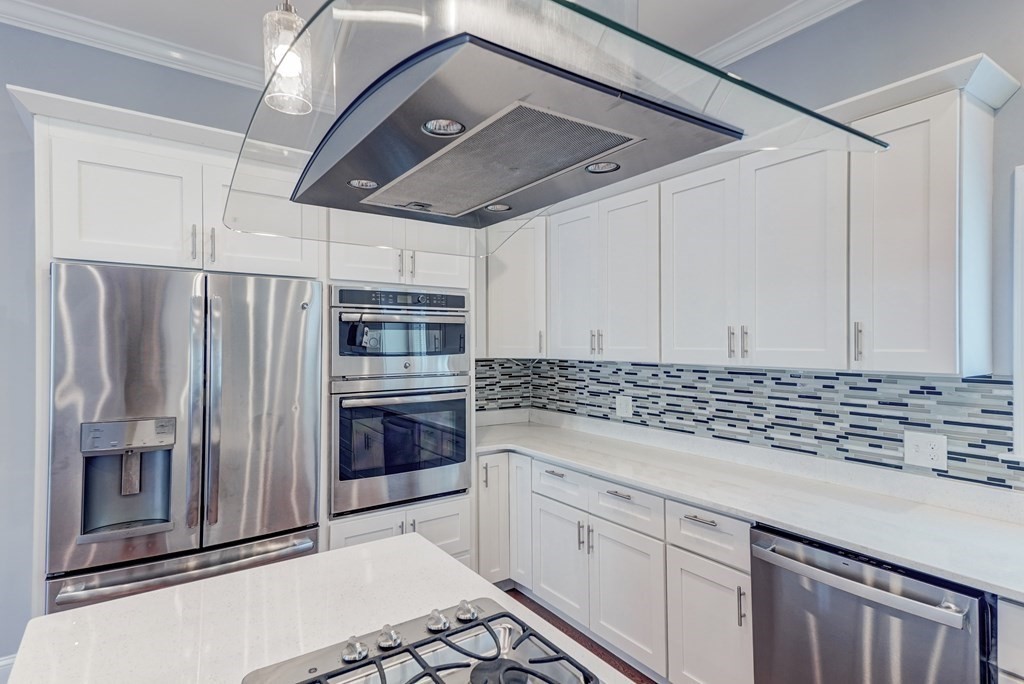 1008-1010 River Street, Unit 1 Boston, MA 02136 - Photo 8 of 29 a kitchen with stainless steel appliances granite countertop a refrigerator and a stove top oven