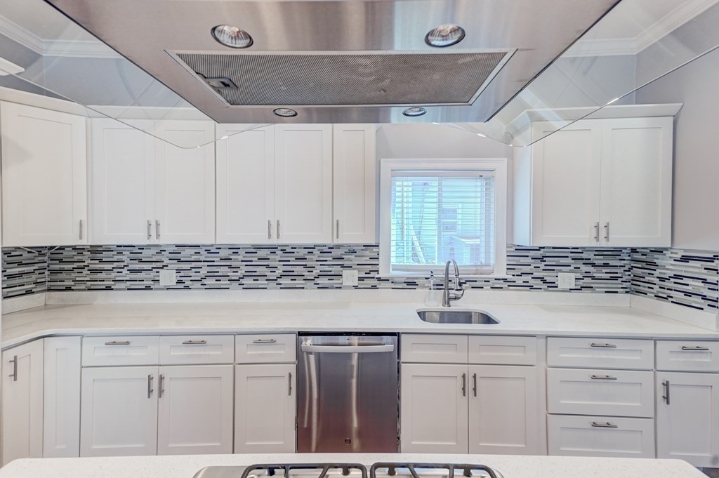 1008-1010 River Street, Unit 1 Boston, MA 02136 - Photo 9 of 29 a kitchen with cabinets appliances and a counter top
