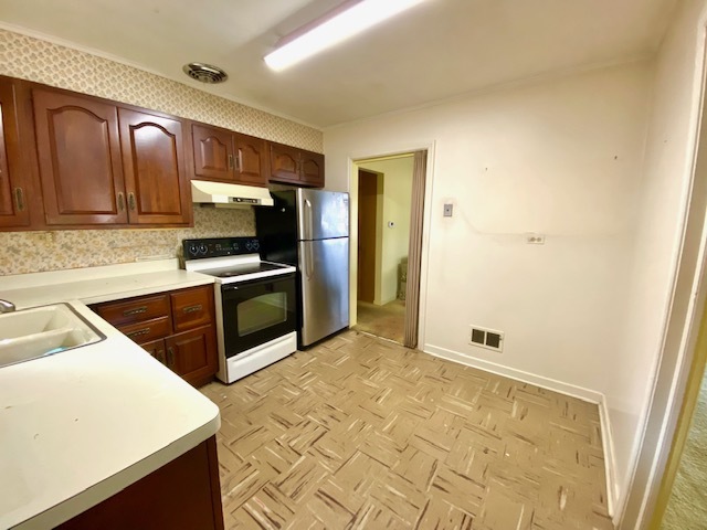 1026 Midway Road Northbrook, IL 60062 - Photo 8 of 17 a kitchen with granite countertop a sink a stove top oven a refrigerator and a cabinets