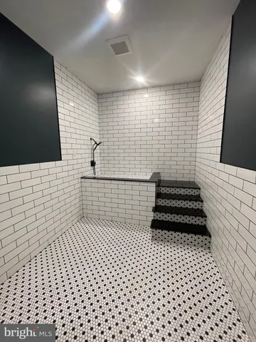 a bathroom with a black white checkered floor