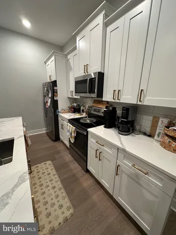 a kitchen with a sink a stove and cabinets