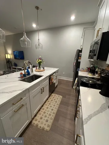 a kitchen with a sink appliances and cabinets