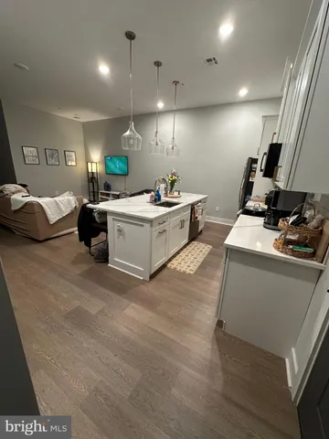 a kitchen with a sink appliances and cabinets