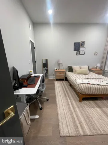 a bedroom with a bed a desk and chair