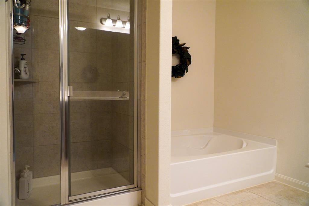 13624 Helix Bridge Way Crowley, TX 76036 - Photo 19 of 25 a white bath tub sitting next to a shower