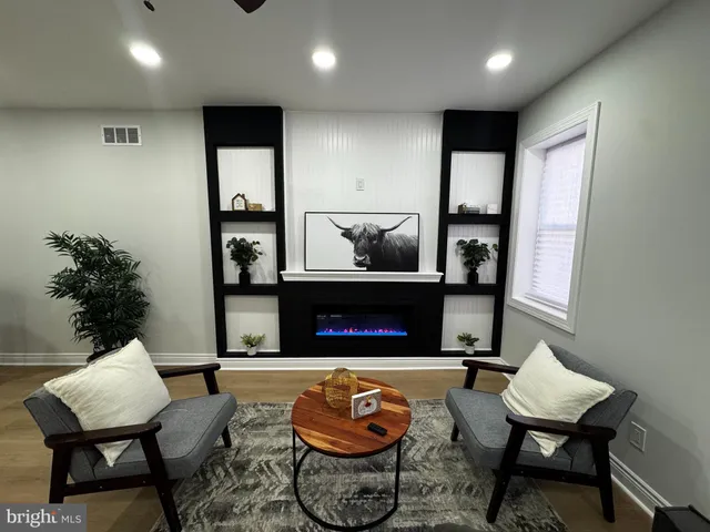 a living room with furniture and a lamp