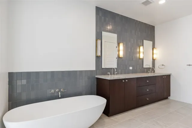 a bathroom with a double vanity sink and mirror