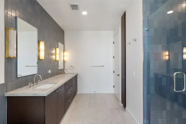 a bathroom with a granite countertop sink a toilet and shower