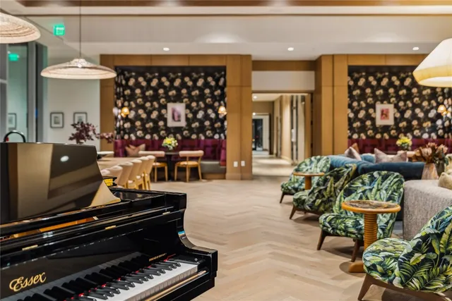 a living room with large windows and furniture