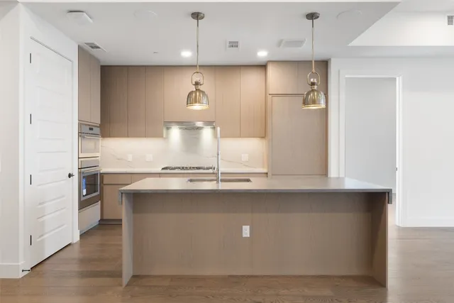 a view of a kitchen with a refrigerator and a sink