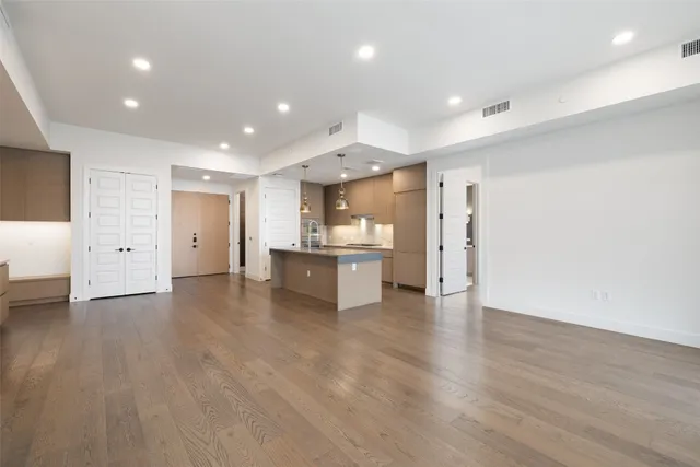 a kitchen with kitchen island stainless steel appliances a sink stove and refrigerator