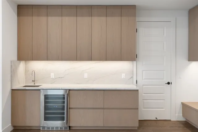 a kitchen with sink and refrigerator