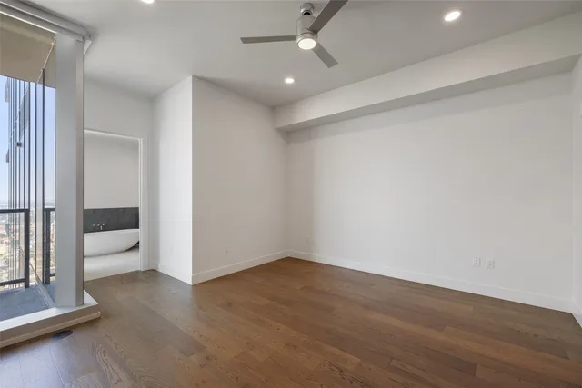 an empty room with wooden floor and closet
