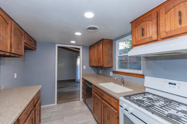 a kitchen with a stove and a sink