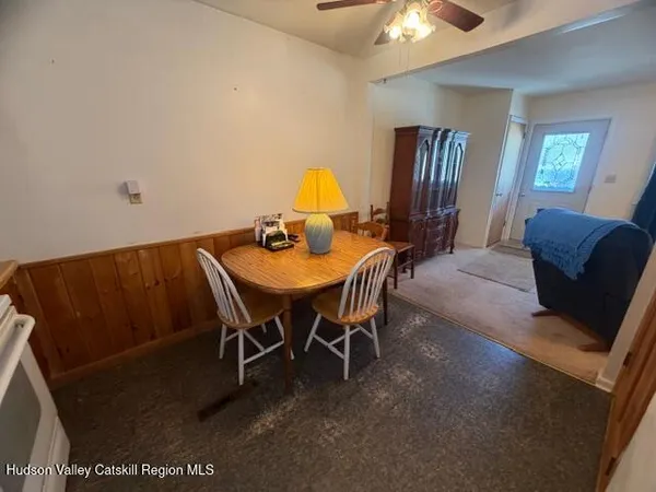 a dining room with furniture and window