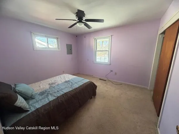 a bedroom with a bed and a window