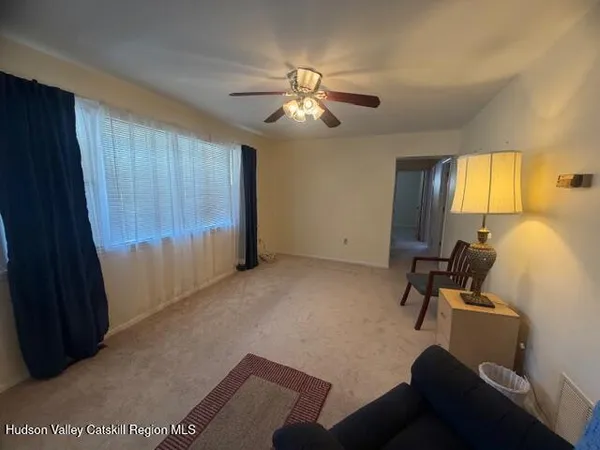 a view of a livingroom with workspace and a window