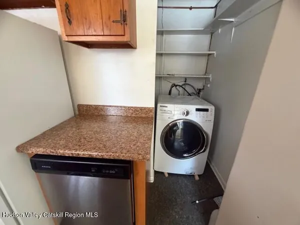 a close view of a utility room with dryer and washer