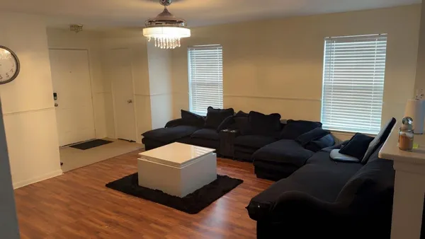 a living room with furniture and a chandelier