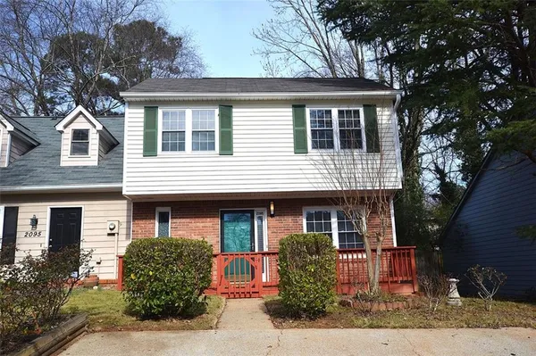 front view of house that has a tree in front of the house