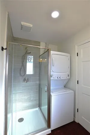 a bathroom with a shower a toilet and sink