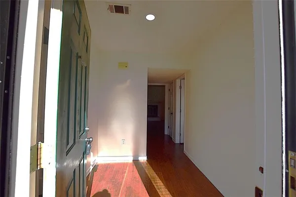 a view of hallway with wooden floor