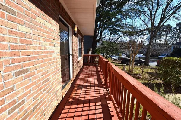 a view of balcony with wooden floor and fence and floor