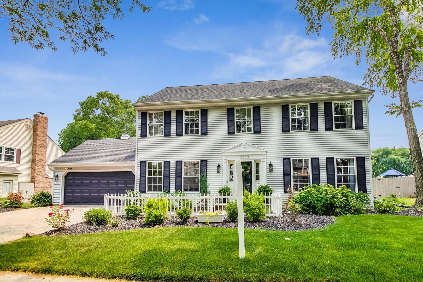 2230 Forest Ridge Road St. Charles, IL 60174 - Photo 2 of 37 a front view of a house with a yard and garage