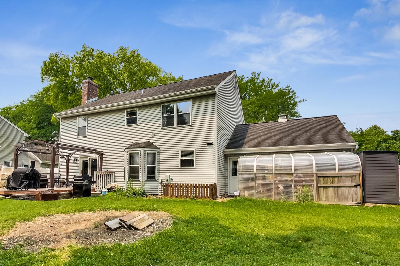 2230 Forest Ridge Road St. Charles, IL 60174 - Photo 34 of 37 a front view of a house with a garden and yard