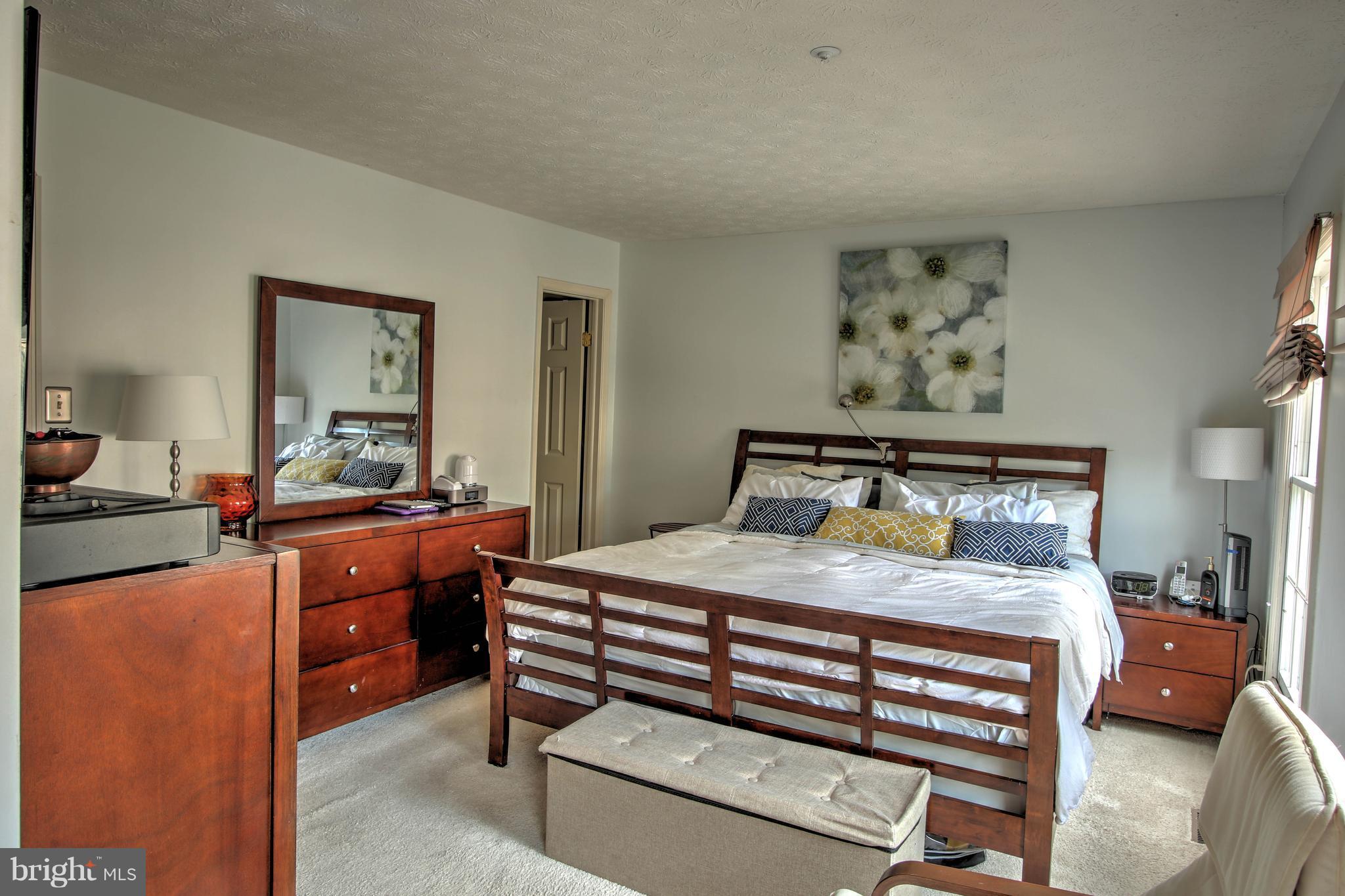 704 Streamside Drive Bowie, MD 20721 - Photo 11 of 24 a bedroom with a bed and a dresser in it