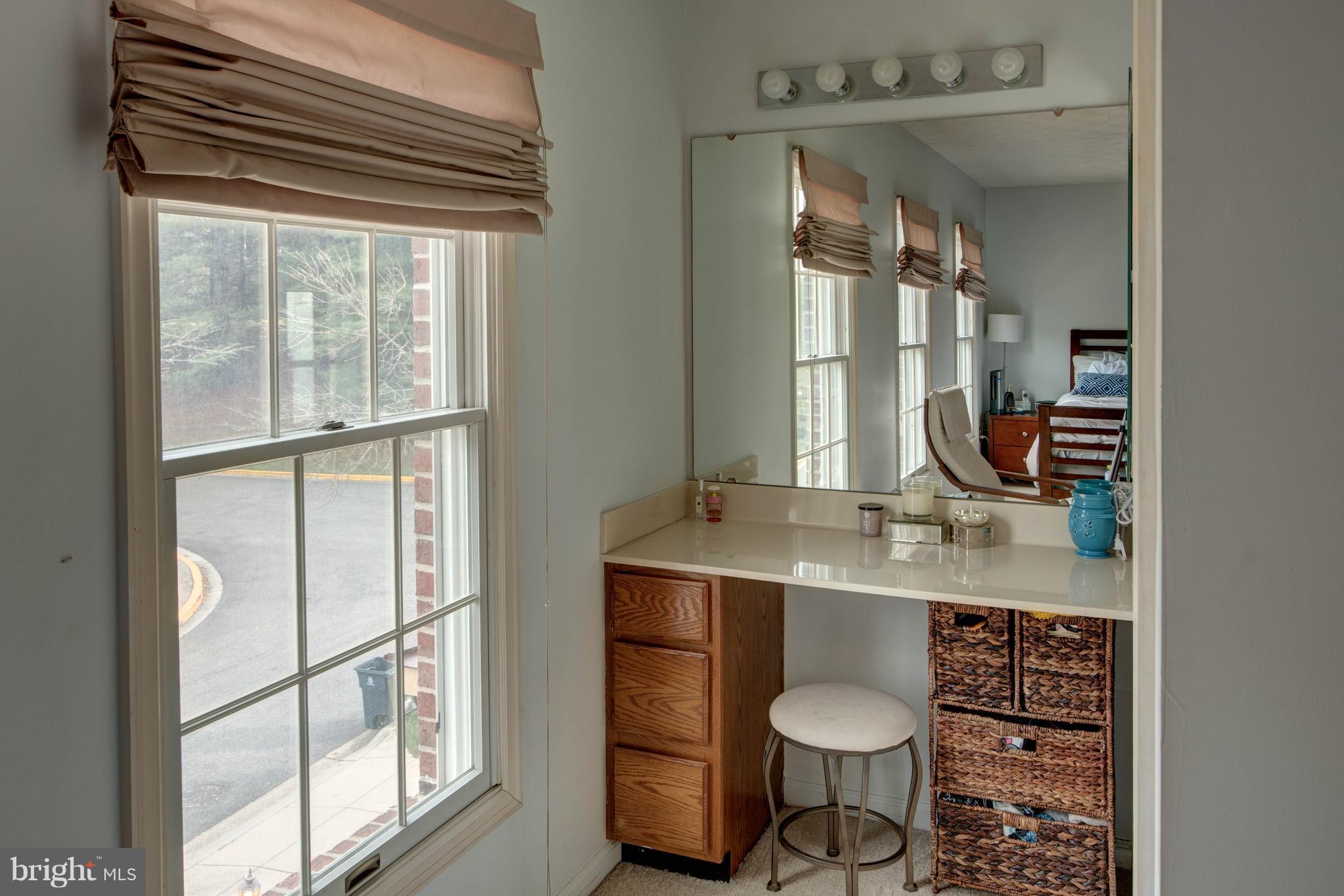 704 Streamside Drive Bowie, MD 20721 - Photo 12 of 24 a bathroom with a granite countertop sink toilet a mirror and next to a window