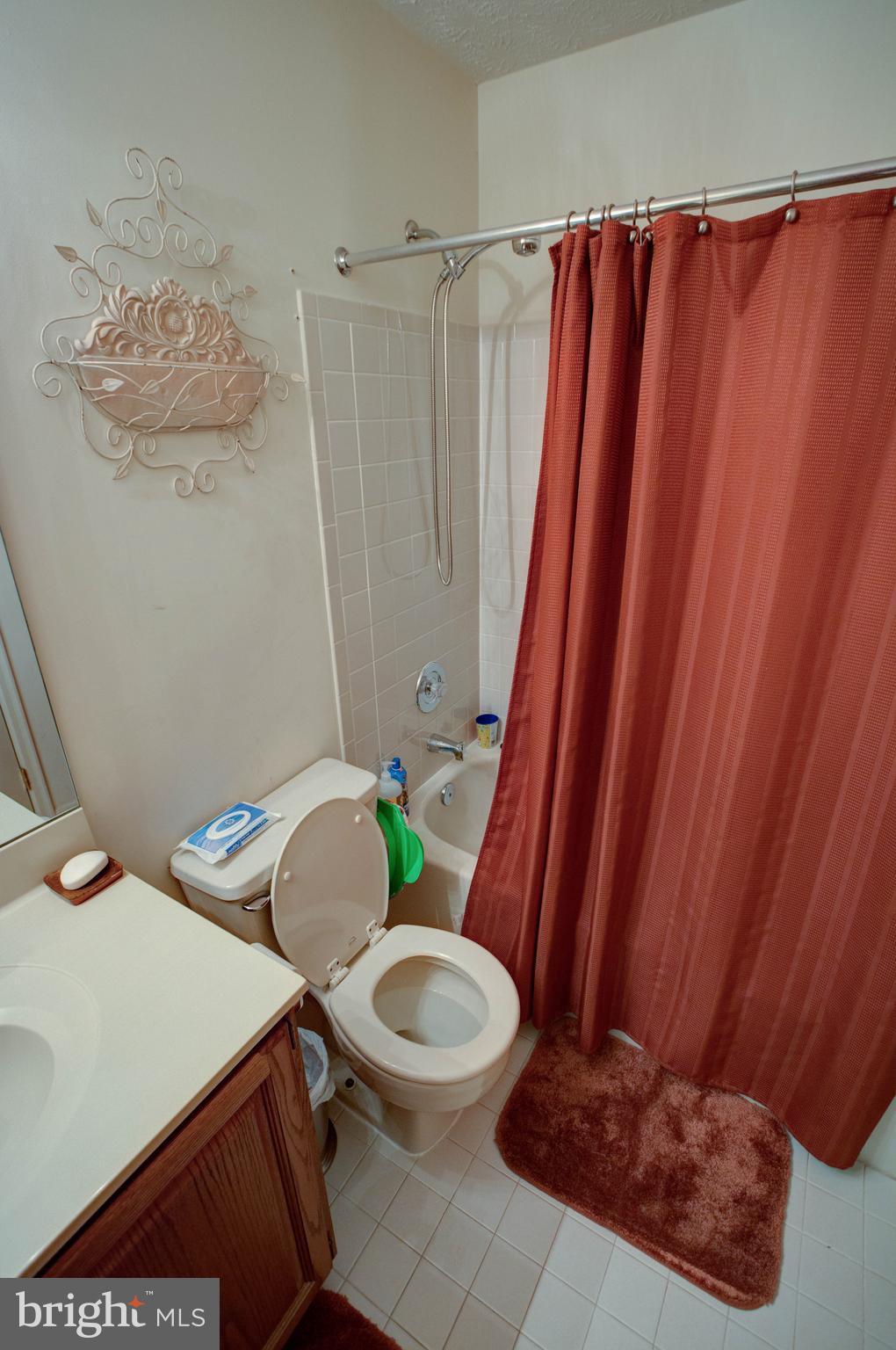 704 Streamside Drive Bowie, MD 20721 - Photo 14 of 24 a bathroom with a sink and toilet