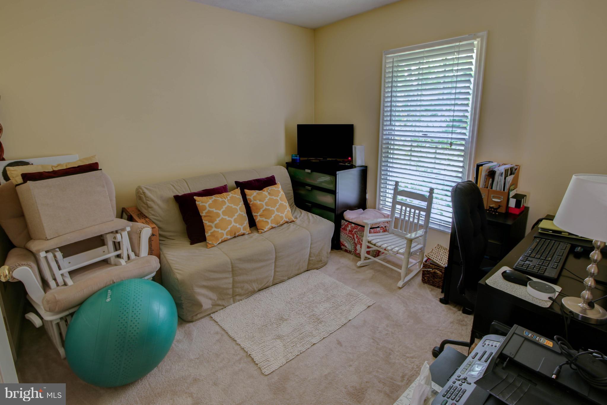 704 Streamside Drive Bowie, MD 20721 - Photo 15 of 24 a living room with furniture and a flat screen tv
