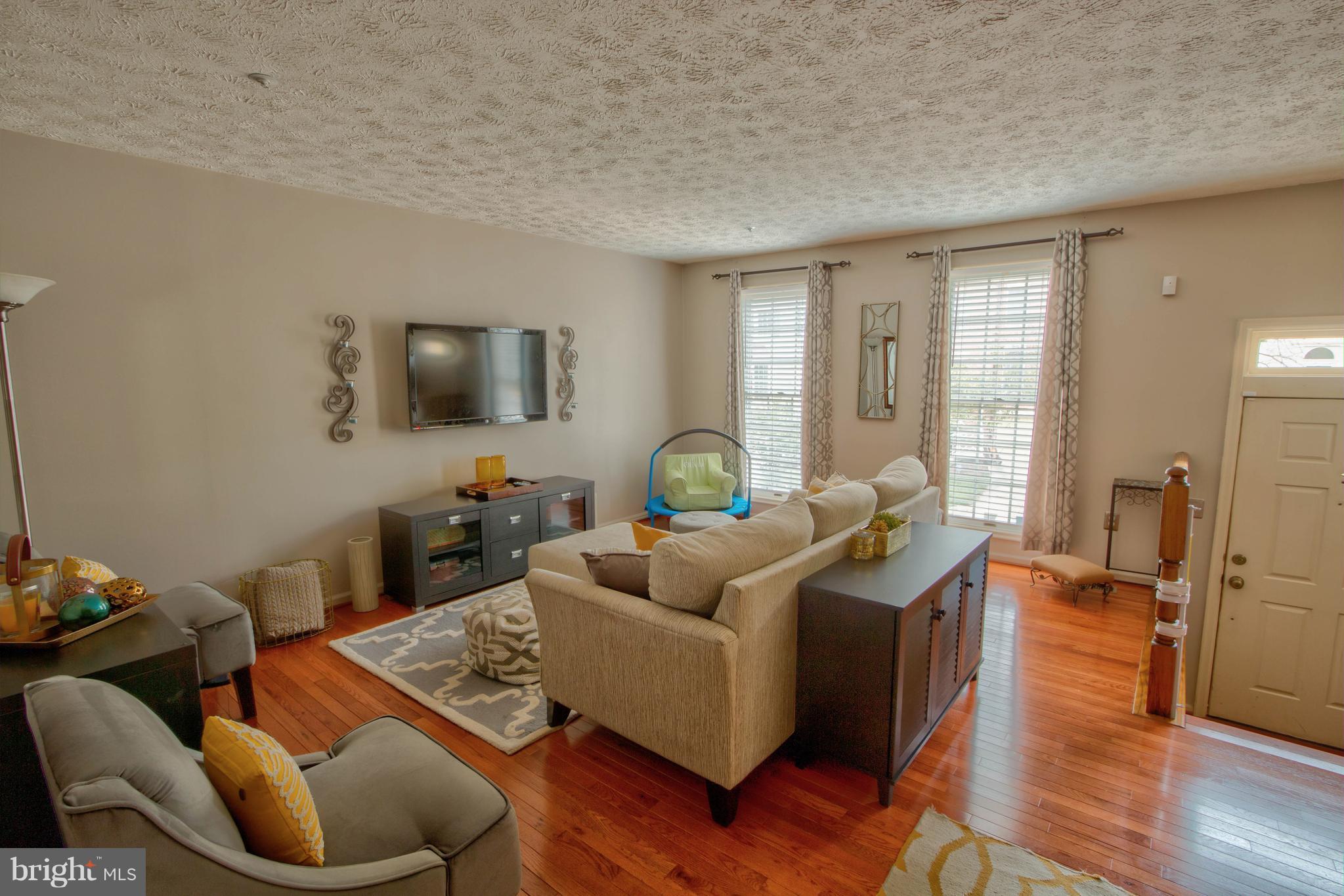704 Streamside Drive Bowie, MD 20721 - Photo 17 of 24 a living room with furniture and a flat screen tv
