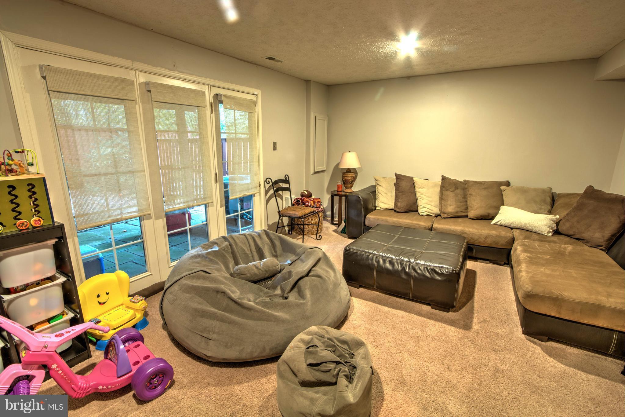 704 Streamside Drive Bowie, MD 20721 - Photo 20 of 24 a living room with furniture and a floor to ceiling window