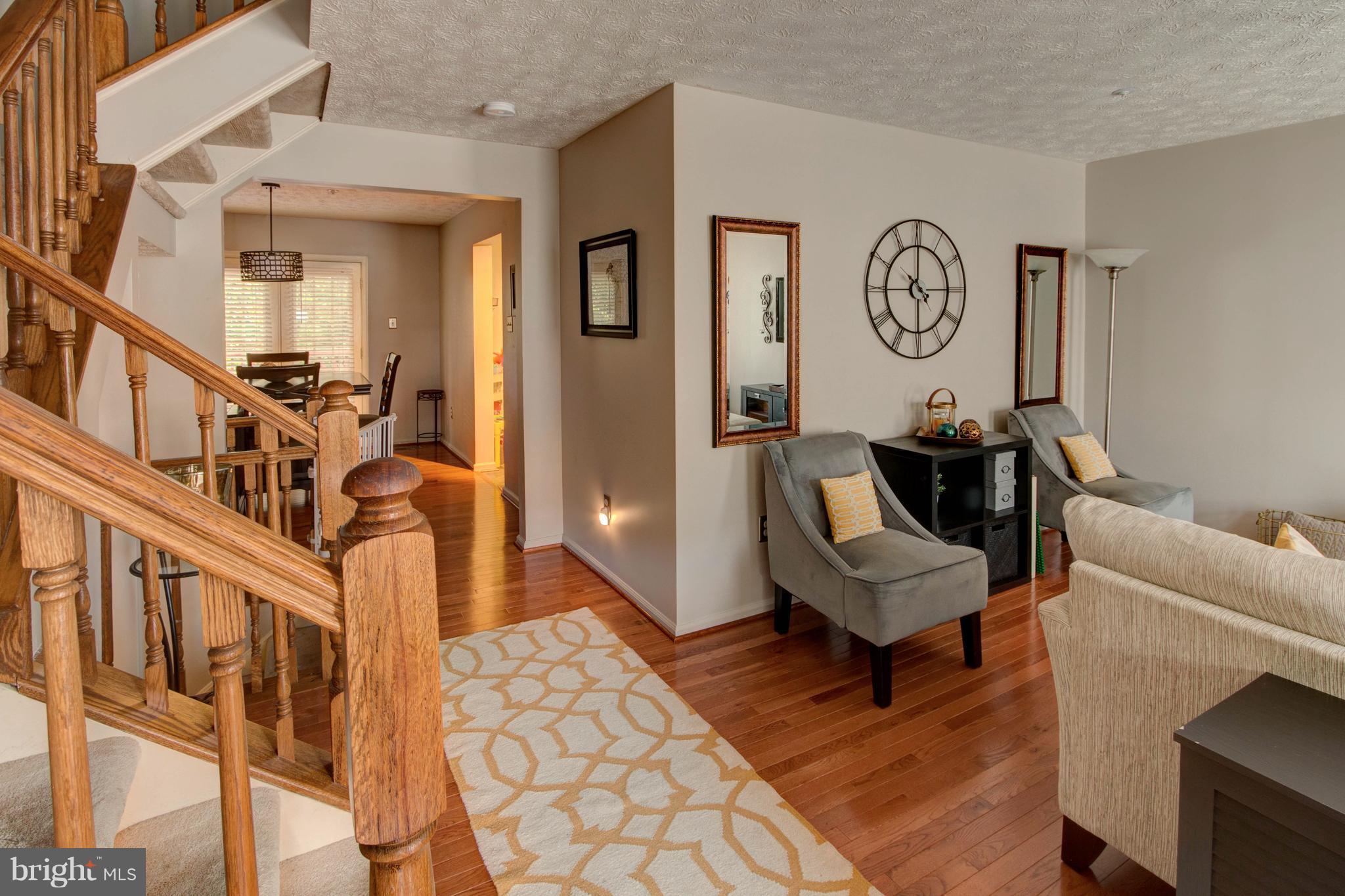 704 Streamside Drive Bowie, MD 20721 - Photo 3 of 24 a living room with furniture and a clock