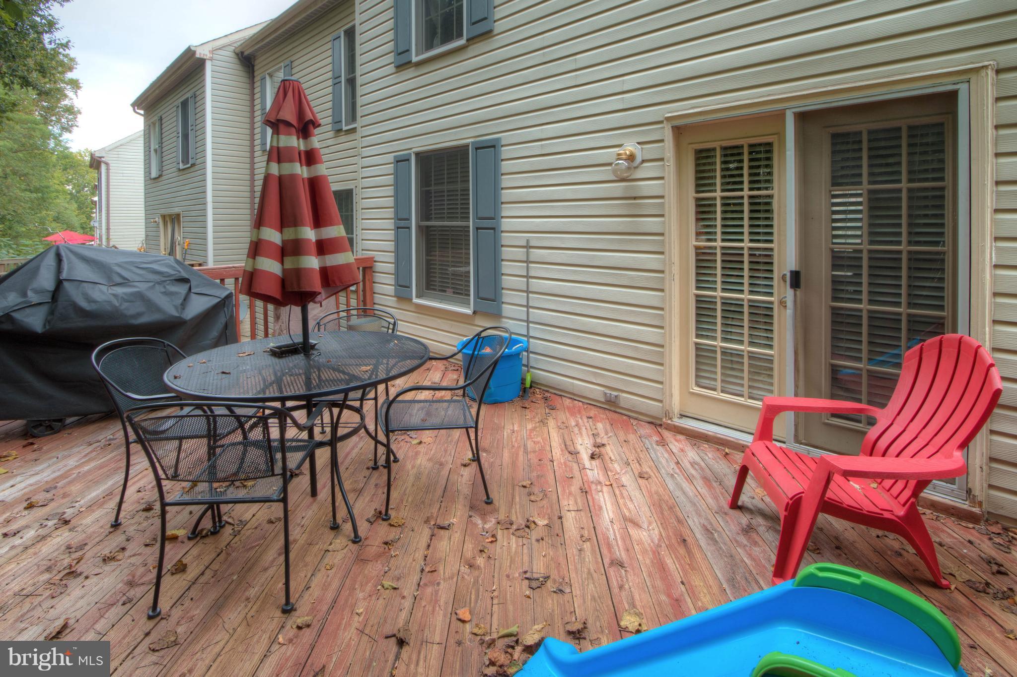 704 Streamside Drive Bowie, MD 20721 - Photo 21 of 24 a backyard of a house with table and chairs