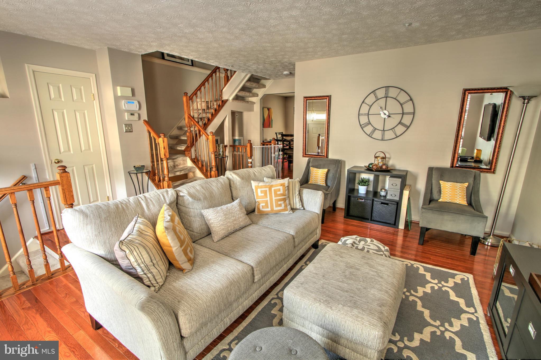 704 Streamside Drive Bowie, MD 20721 - Photo 4 of 24 a living room with furniture and a wooden floor