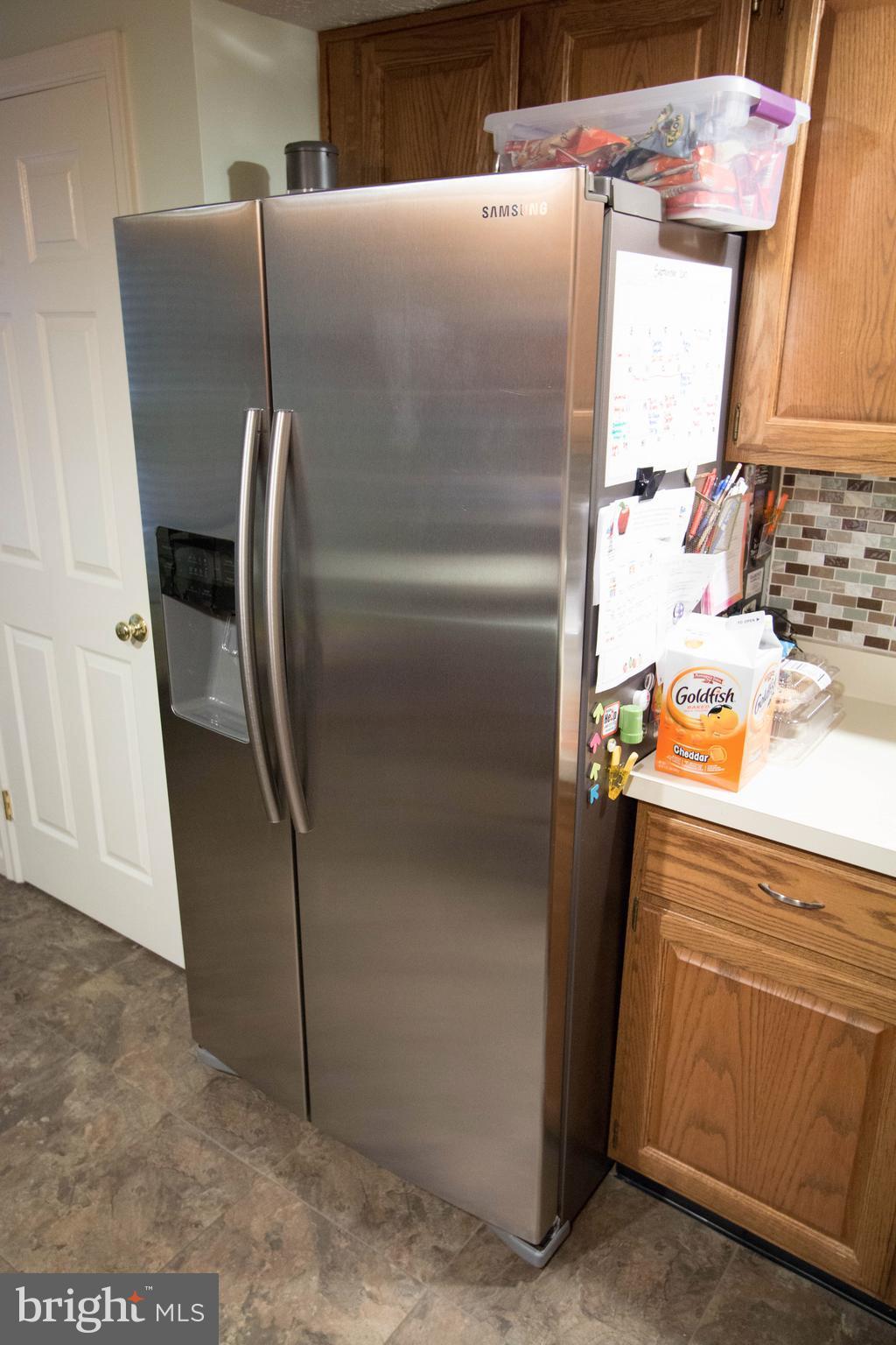 704 Streamside Drive Bowie, MD 20721 - Photo 7 of 24 a close view of a sink and refrigerator