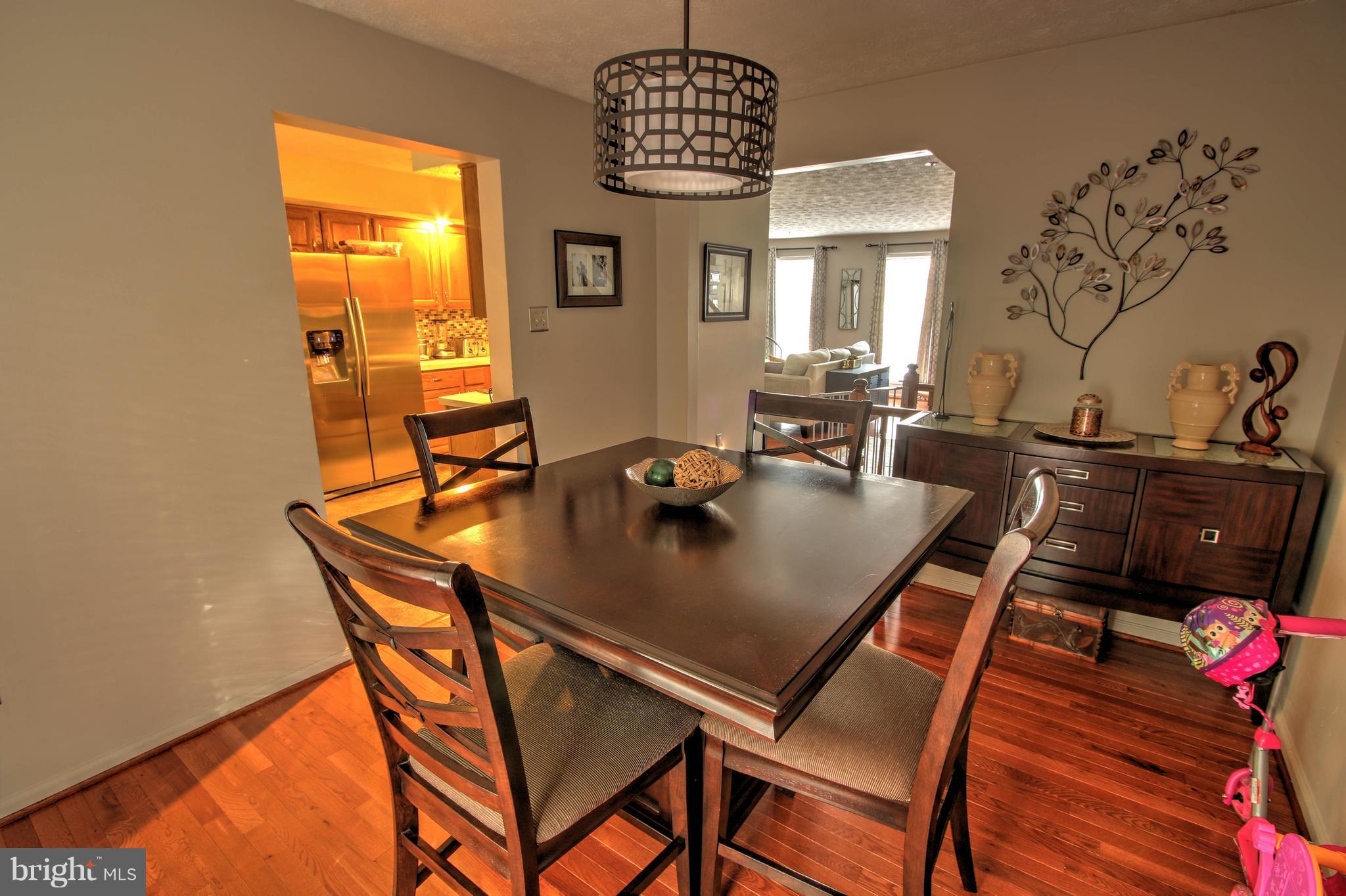 704 Streamside Drive Bowie, MD 20721 - Photo 8 of 24 a view of a dining room with furniture and wooden floor