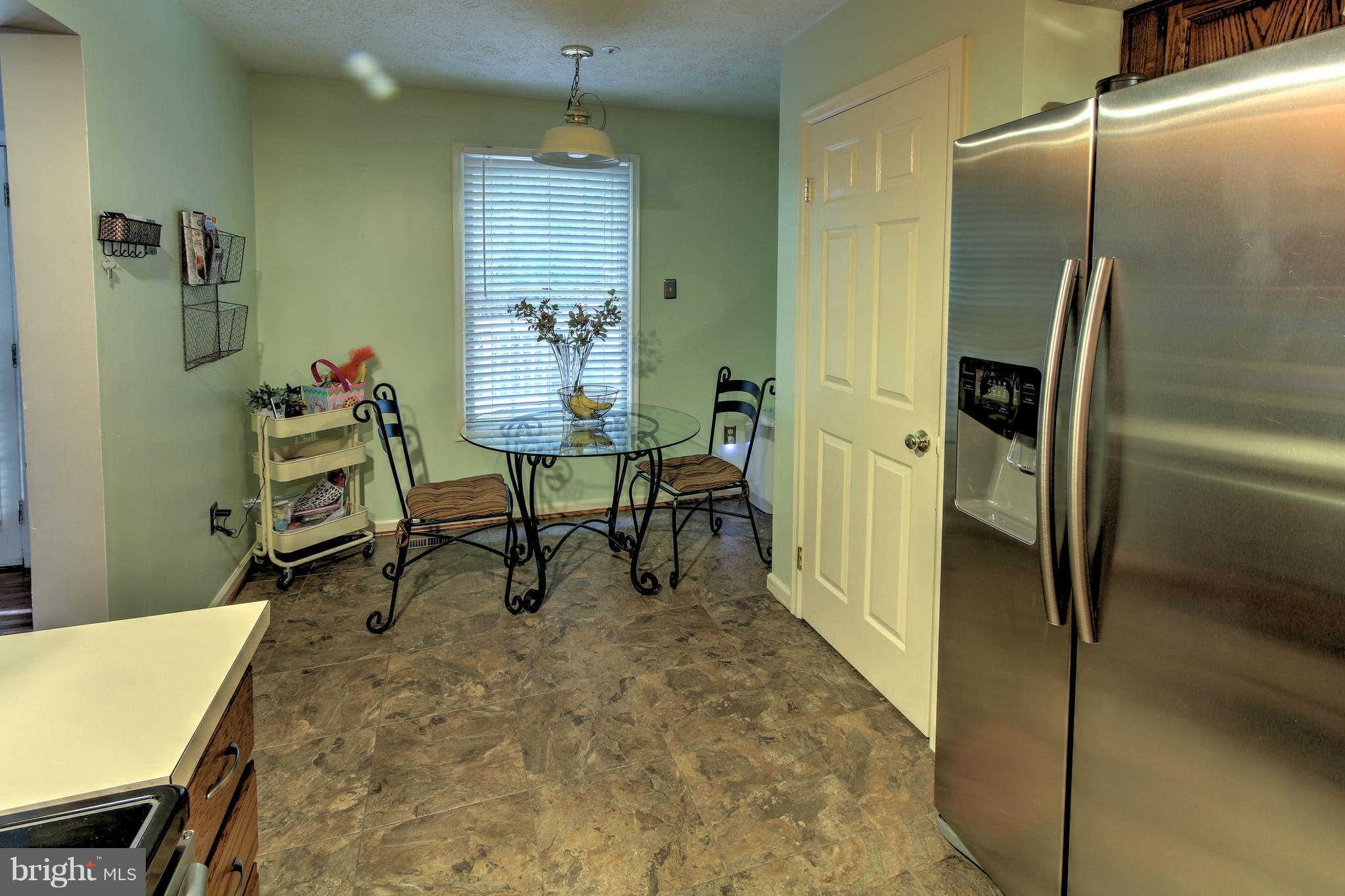 704 Streamside Drive Bowie, MD 20721 - Photo 9 of 24 a room with table and chair
