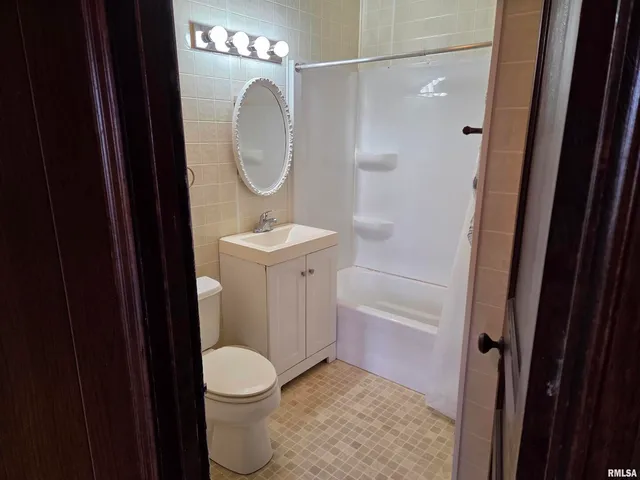 a bathroom with a shower and toilet