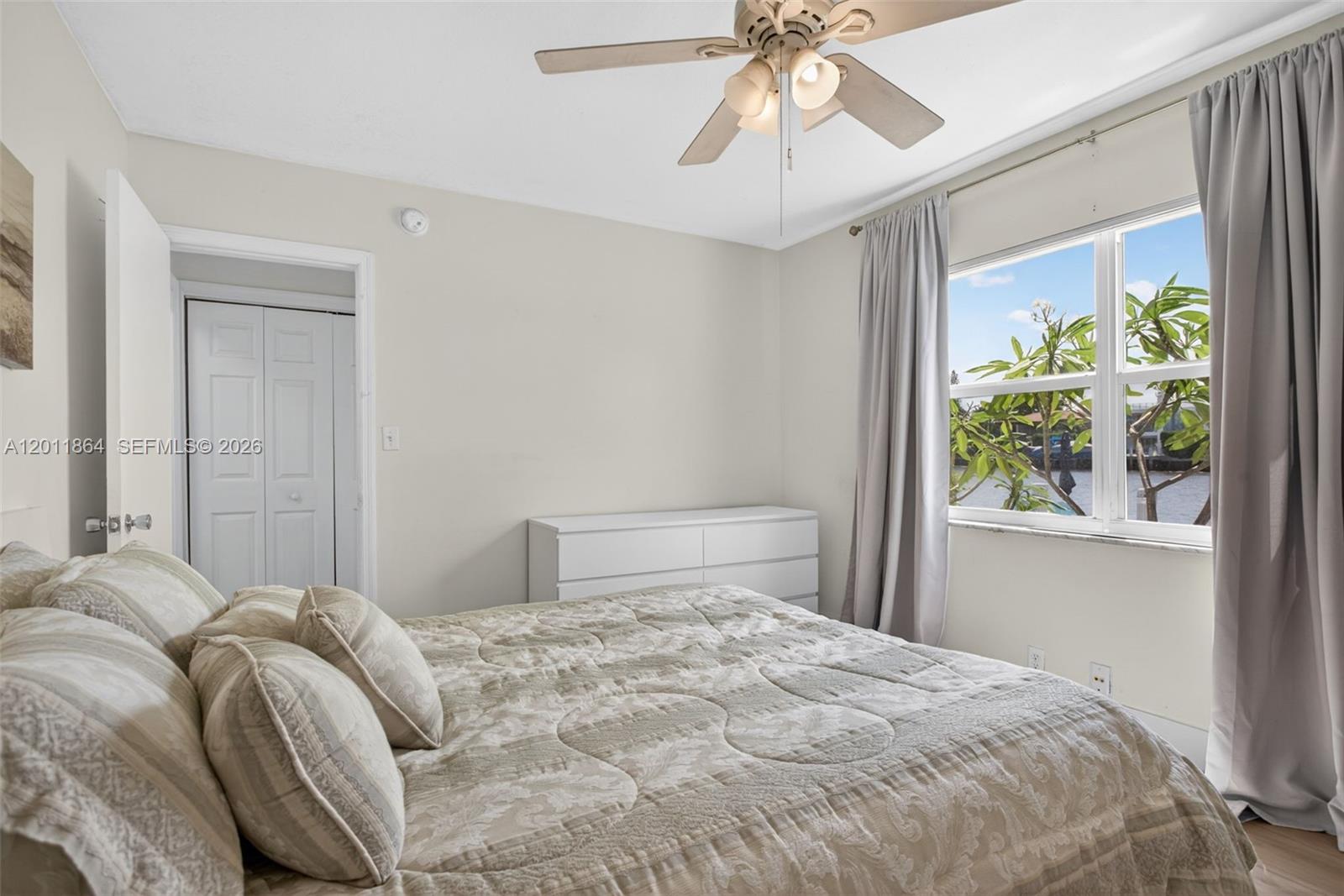 615 South Riverside Drive, Unit 5 Pompano Beach, FL 33062 - Photo 18 of 29 a bedroom with a bed and a chandelier