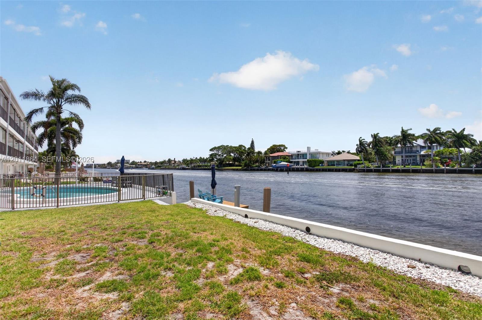 615 South Riverside Drive, Unit 5 Pompano Beach, FL 33062 - Photo 22 of 29 a swimming pool with an outdoor space and seating in the back